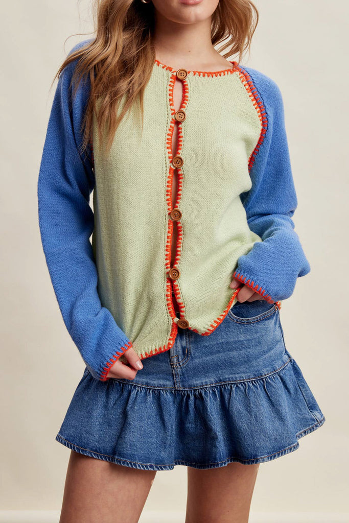 knit raglan-style cardigan with a color blocked design and special blanket stitched details