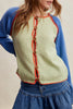 knit raglan-style cardigan with a color blocked design and special blanket stitched details
