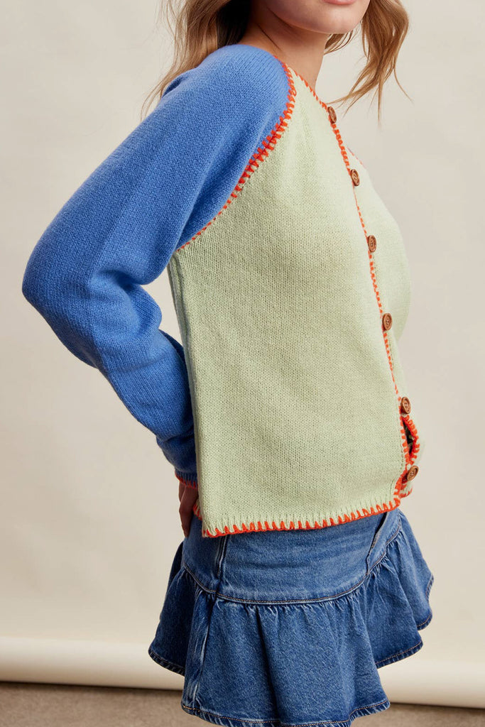 knit raglan-style cardigan with a color blocked design and special blanket stitched details