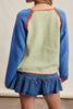 knit raglan-style cardigan with a color blocked design and special blanket stitched details