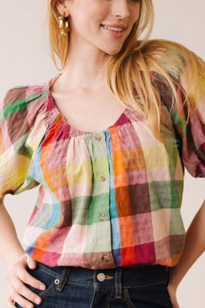 button down top with a scoop neckline, puff sleeves, and a colorful plaid pattern