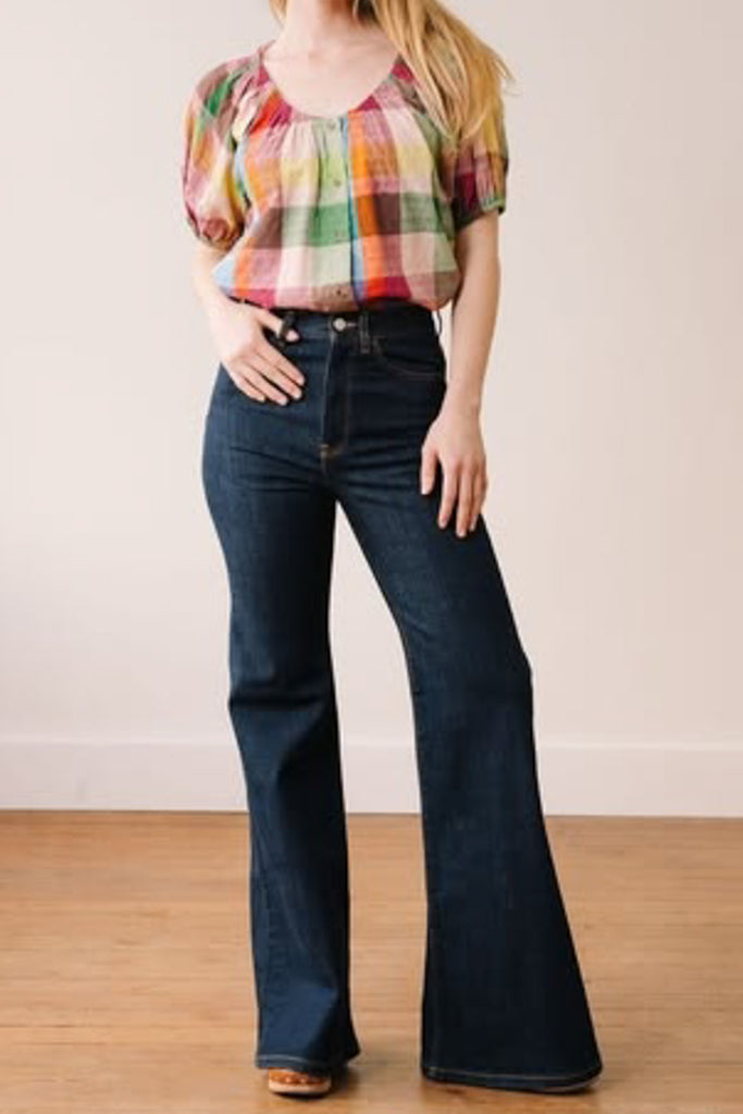 button down top with a scoop neckline, puff sleeves, and a colorful plaid pattern
