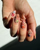 whimsical nail stickers applied to a manicure