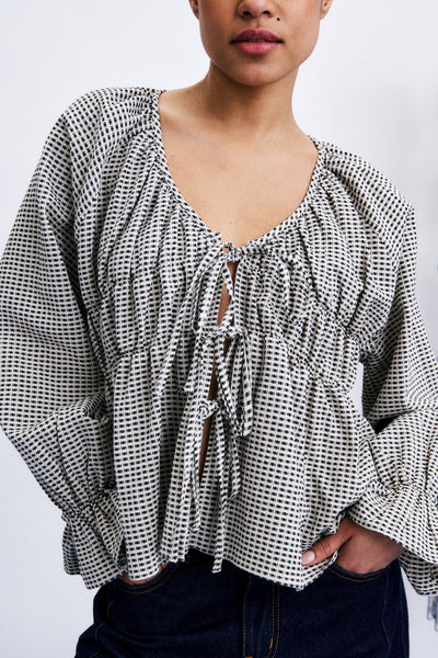 flowy tie front blouse in a black and white geometric print