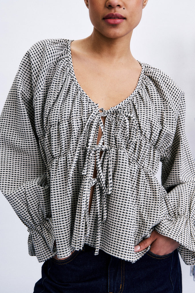 flowy tie front blouse in a black and white geometric print