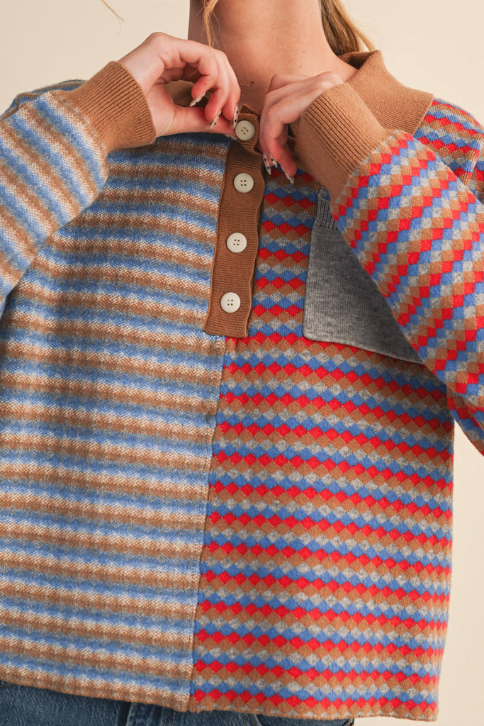 unique sweater in camel, grey, bright blue, and red stripes.