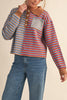 unique sweater in camel, grey, bright blue, and red stripes.
