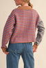 unique sweater in camel, grey, bright blue, and red stripes.