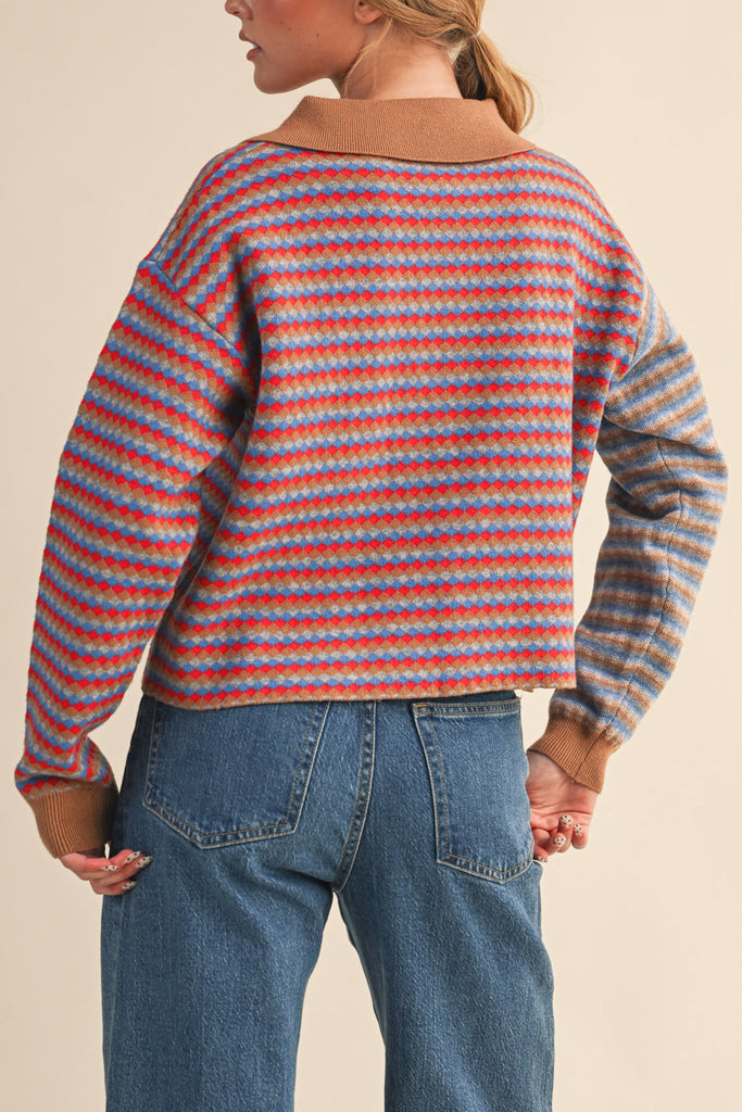 unique sweater in camel, grey, bright blue, and red stripes.