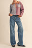 unique sweater in camel, grey, bright blue, and red stripes.