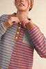 unique sweater in camel, grey, bright blue, and red stripes.