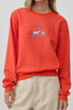 orange crew neck sweatshirt with an embroidered horse design and the message "lucky you."