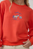 orange crew neck sweatshirt with an embroidered horse design and the message "lucky you."