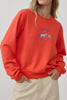 orange crew neck sweatshirt with an embroidered horse design and the message "lucky you."