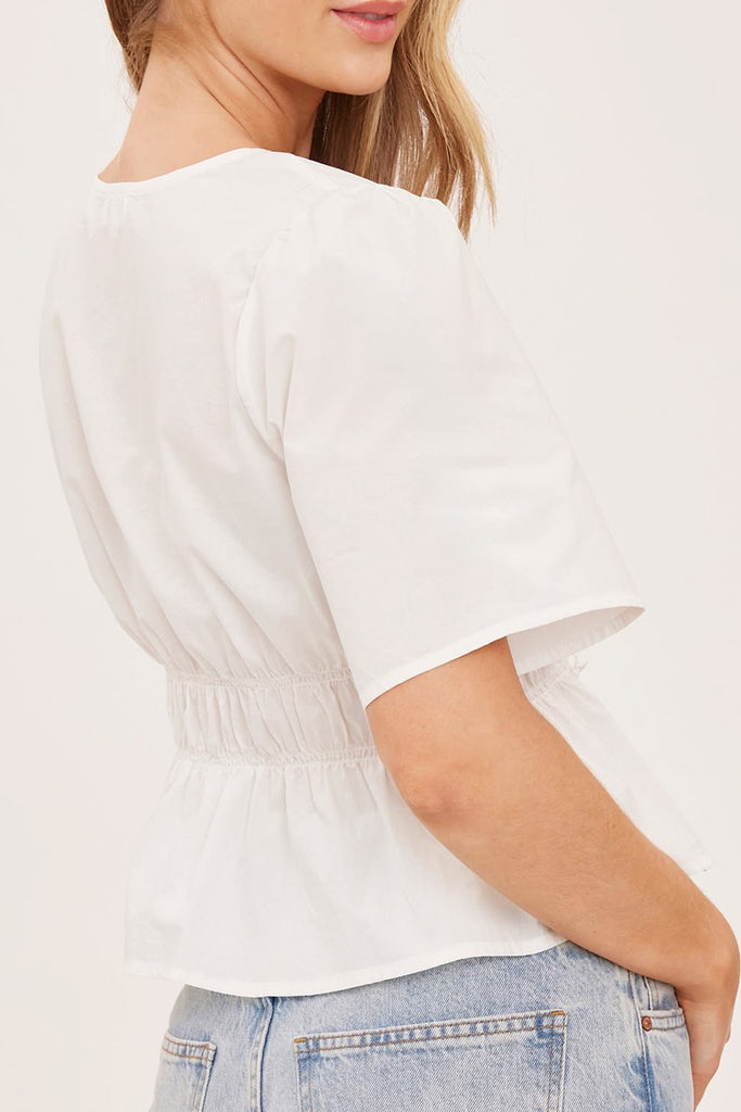 romantic feeling white blouse with v neckline and gathered waist 