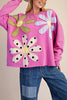 washed magenta sweatshirt with flower applique details