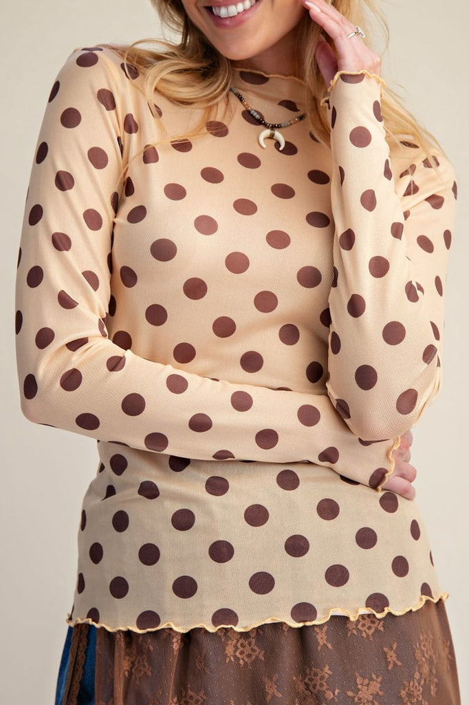 long sleeve mesh top in a pale peachy color with chocolate brown polka dots.
