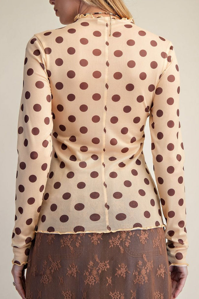 long sleeve mesh top in a pale peachy color with chocolate brown polka dots.