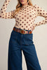 long sleeve mesh top in a pale peachy color with chocolate brown polka dots.