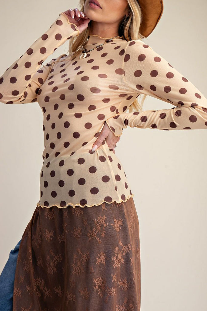 long sleeve mesh top in a pale peachy color with chocolate brown polka dots.