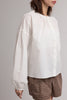 white button down top with a gathered neckline and roomy long sleeves
