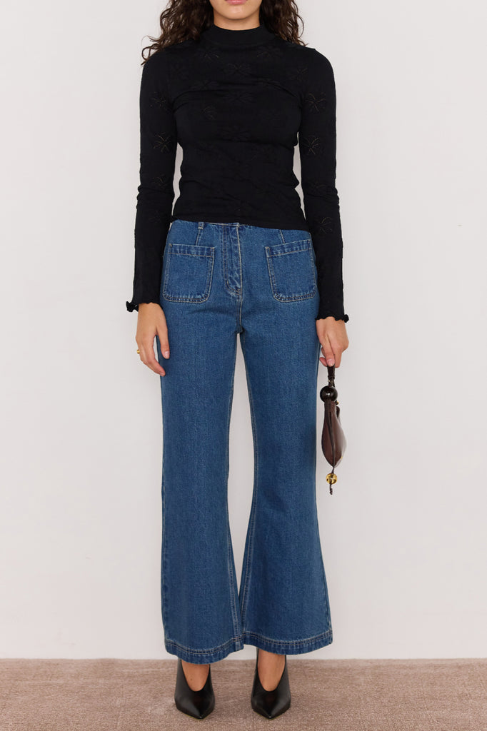 slim-fitting knit top in black with special pointelle detailing throughout