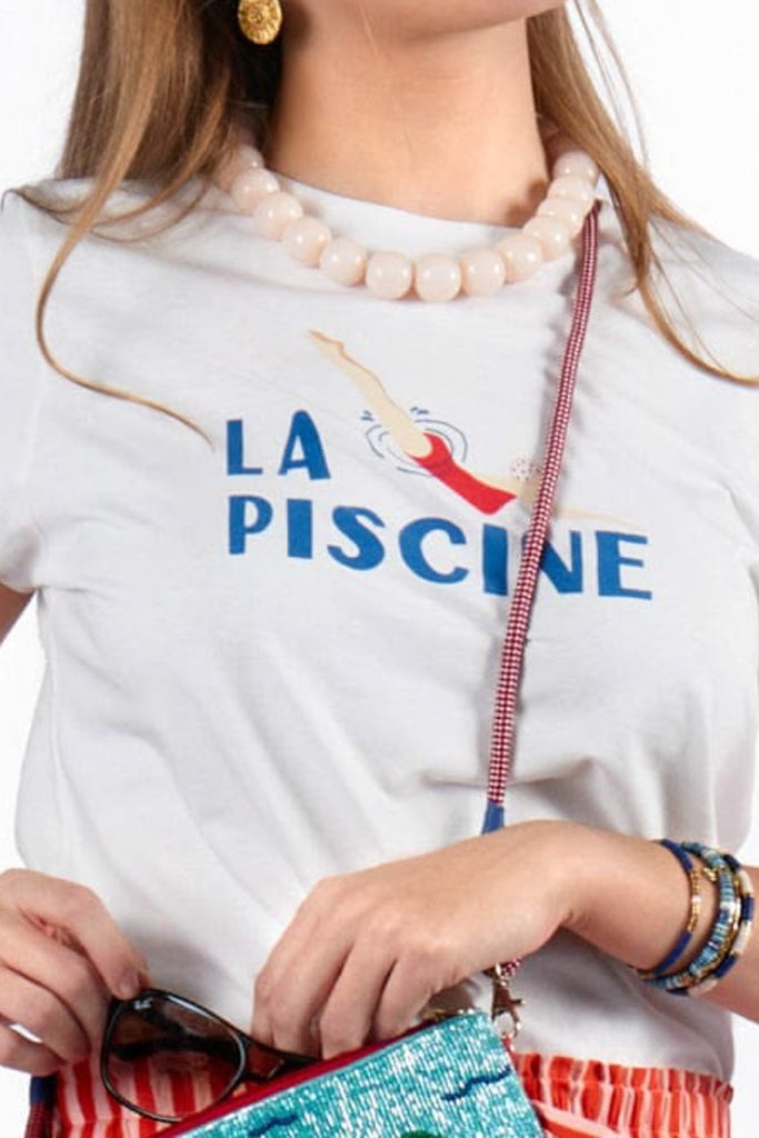 white tee with the message "la piscine" and a cute swimmer graphic