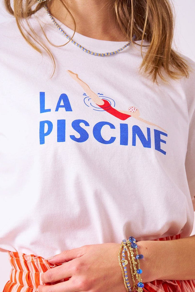 white tee with the message "la piscine" and a cute swimmer graphic