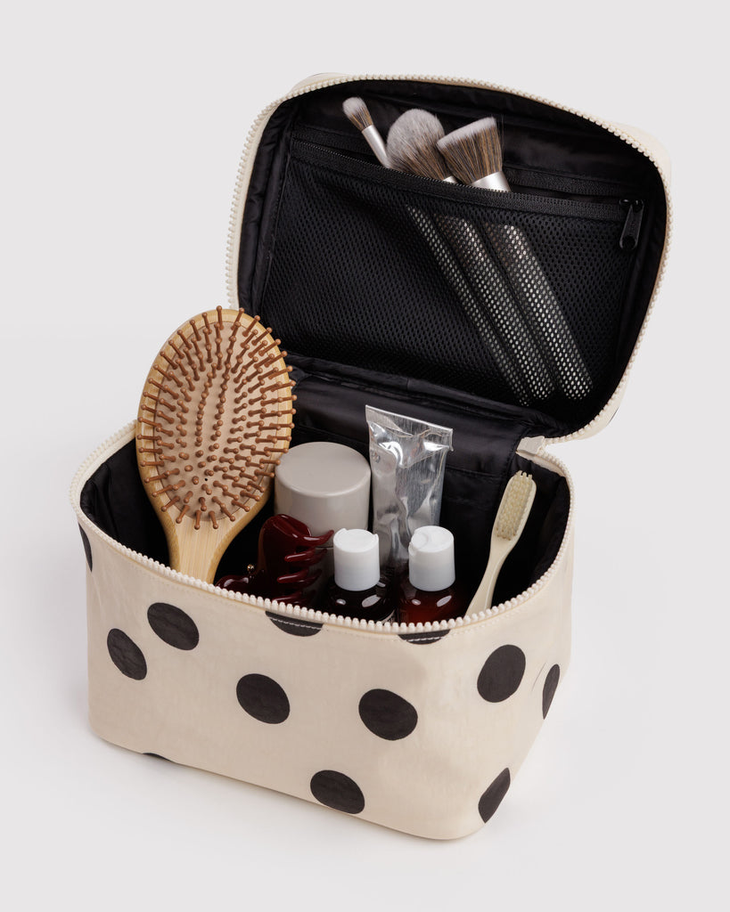 large cosmetic case in a cream and black polka dot print