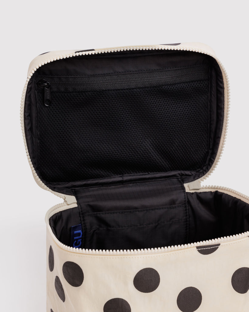 large cosmetic case in a cream and black polka dot print