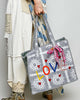 oversized tote bag with a quilted texture and embroidered "love" in bold colors