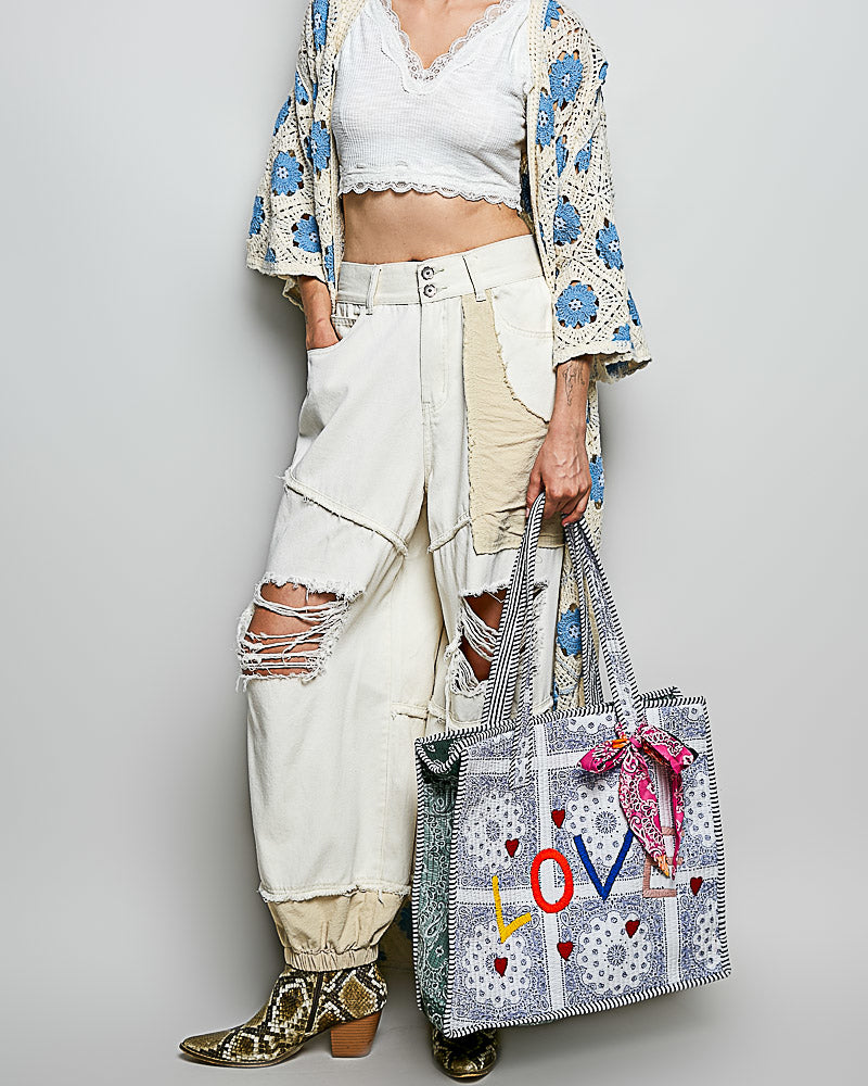 oversized tote bag with a quilted texture and embroidered "love" in bold colors
