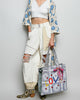 oversized tote bag with a quilted texture and embroidered "love" in bold colors