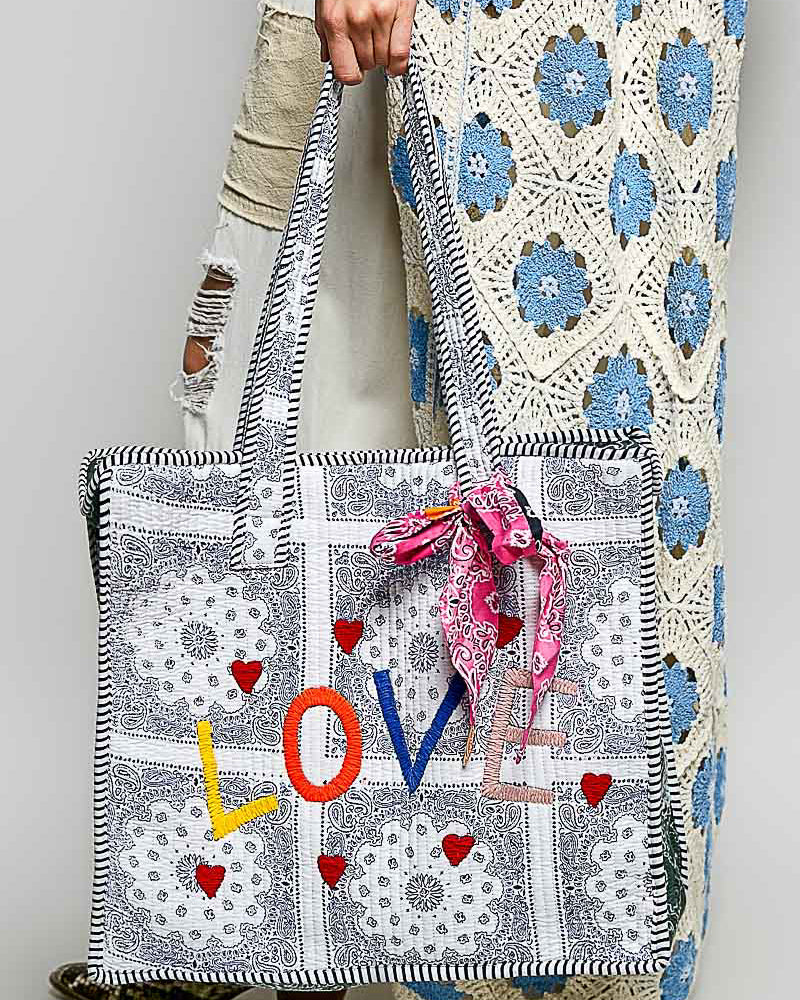 oversized tote bag with a quilted texture and embroidered "love" in bold colors