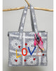oversized tote bag with a quilted texture and embroidered "love" in bold colors