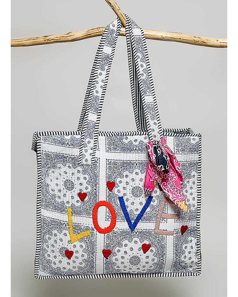 oversized tote bag with a quilted texture and embroidered "love" in bold colors