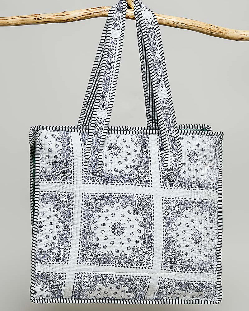 oversized tote bag with a quilted texture and embroidered "love" in bold colors