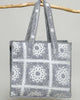 oversized tote bag with a quilted texture and embroidered "love" in bold colors