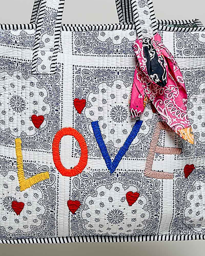 oversized tote bag with a quilted texture and embroidered "love" in bold colors