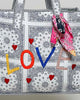 oversized tote bag with a quilted texture and embroidered "love" in bold colors