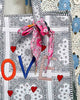 oversized tote bag with a quilted texture and embroidered "love" in bold colors