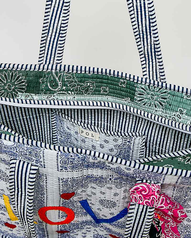 oversized tote bag with a quilted texture and embroidered "love" in bold colors