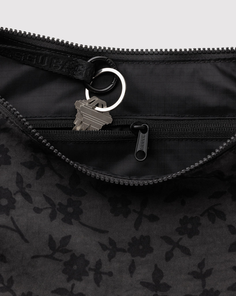 baggu medium nylon crescent bag in a charcoal grey ditsy floral pattern