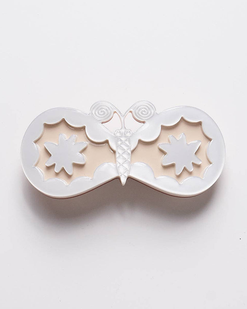 french barrette with a striking moth design in pearly white