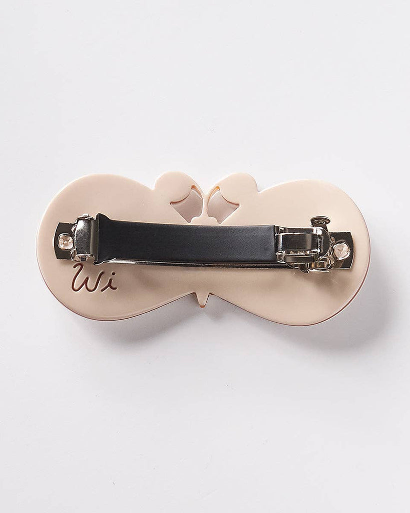 french barrette with a striking moth design in pearly white