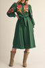dark green midi dress with colorful floral embroidered details