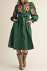 dark green midi dress with colorful floral embroidered details