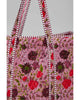oversized quilted tote bag in a purple floral pattern with striped details. 