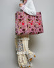 oversized quilted tote bag in a purple floral pattern with striped details. 