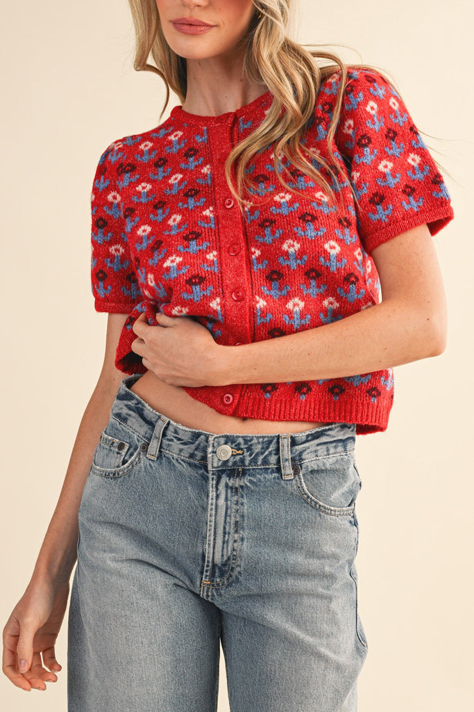 short sleeve button up sweater in red with a colorful floral pattern in cream, burgundy, and light blue.